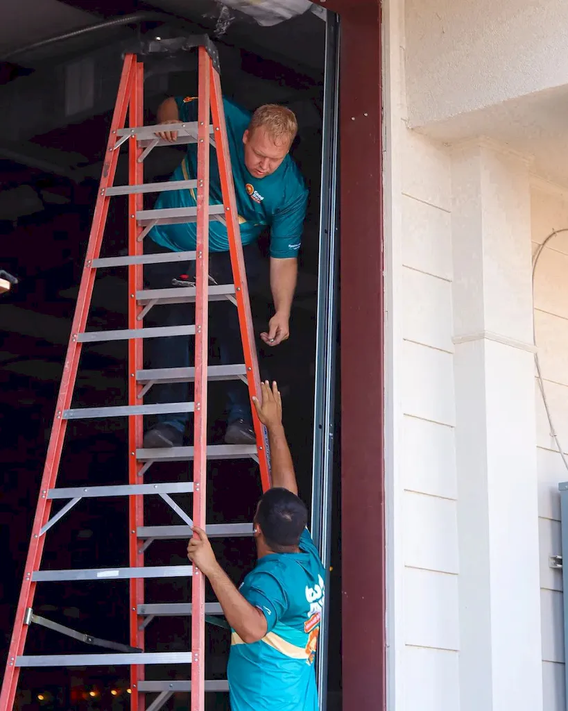 Good Day Garage Doors technicians installing a commercial garage door in Knoxville