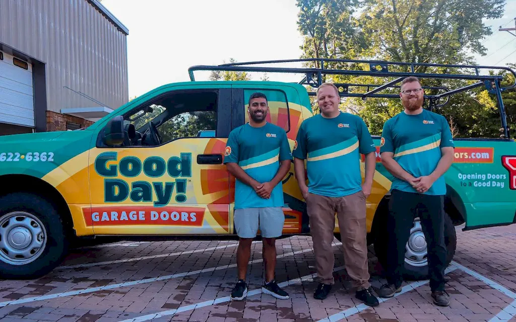 Good Day Garage Doors team standing with branded service truck in Knoxville, TN